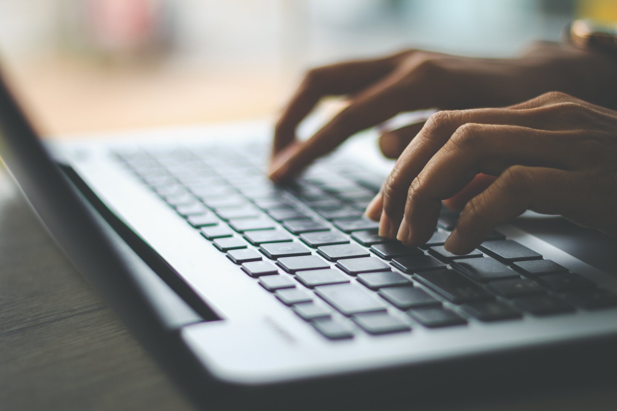 Hands Typing on a Laptop Keyboard 