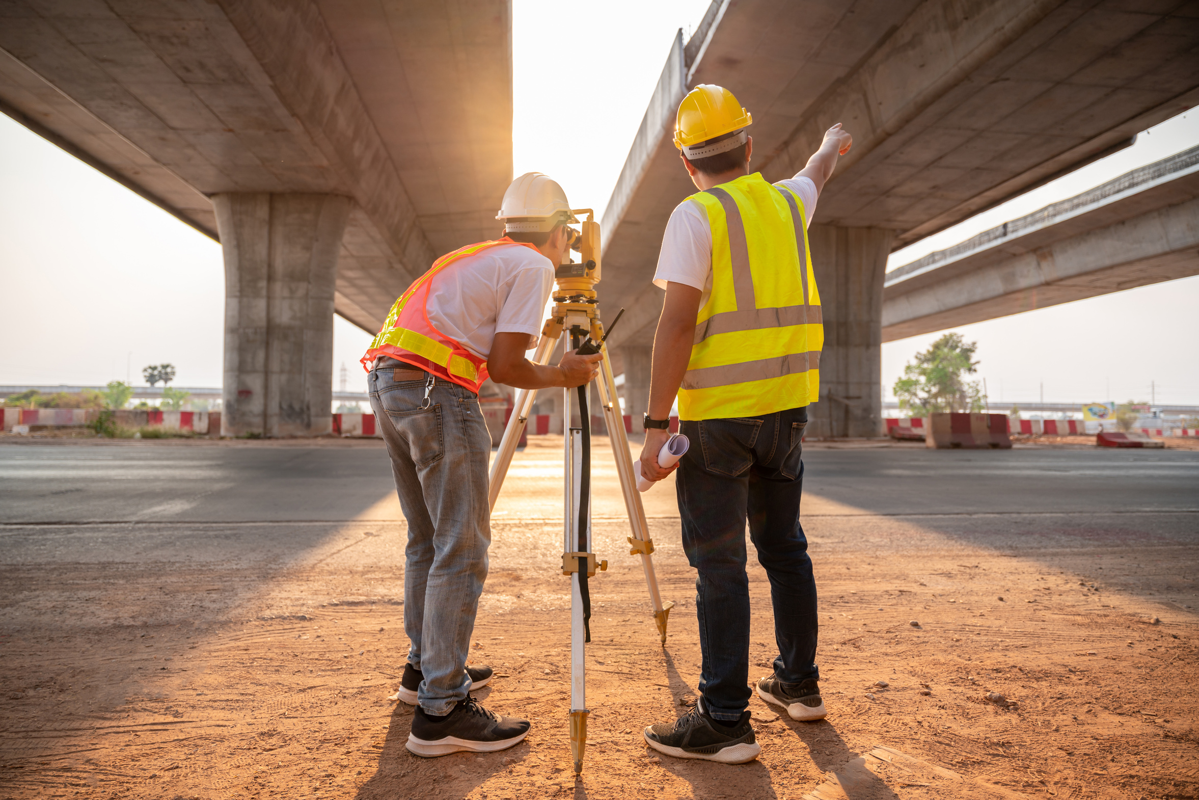 Asian Civil Engineer and Surveyor Engineers Making Measuring and