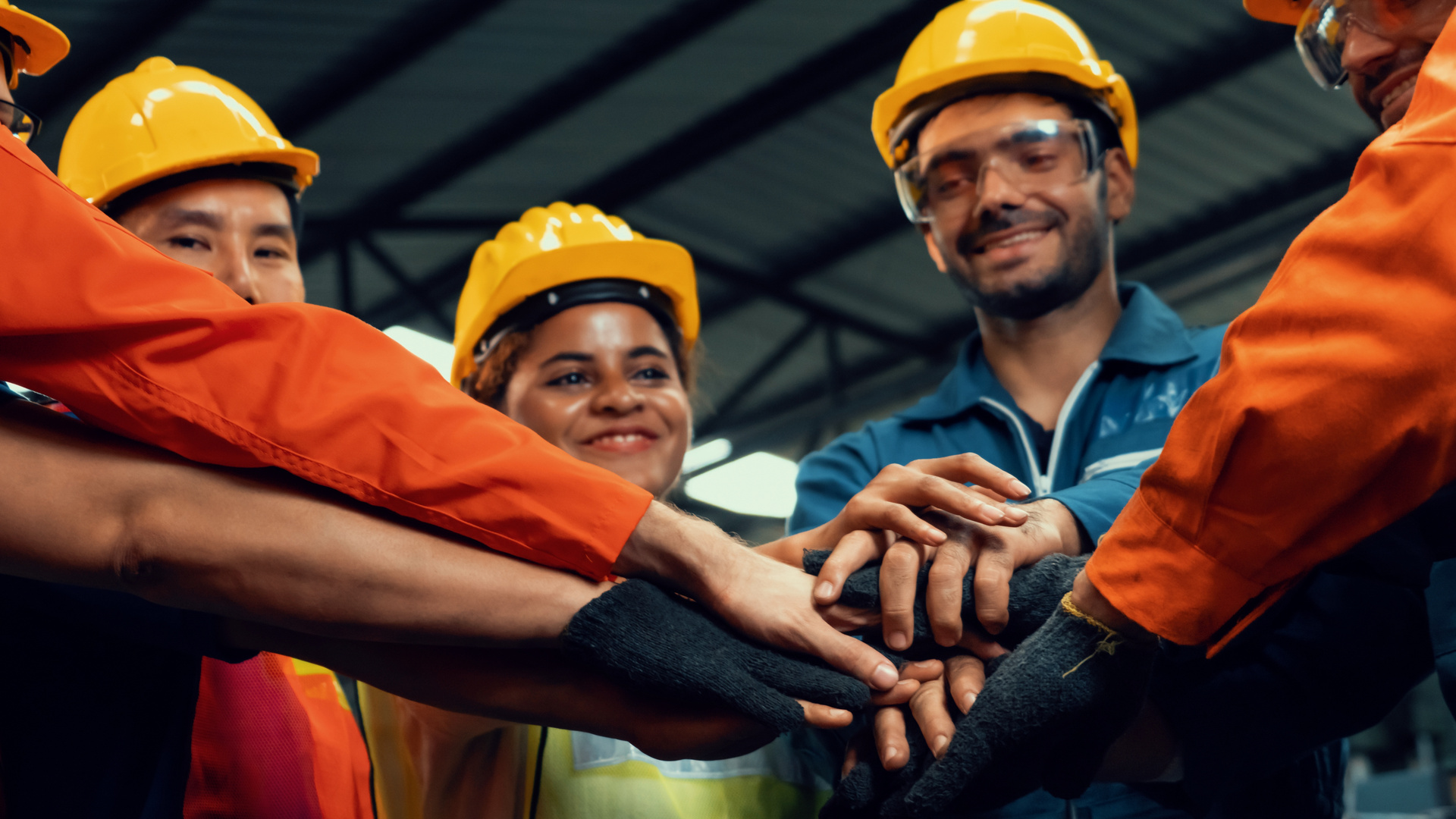 Skillful worker stand together showing teamwork in the factory .